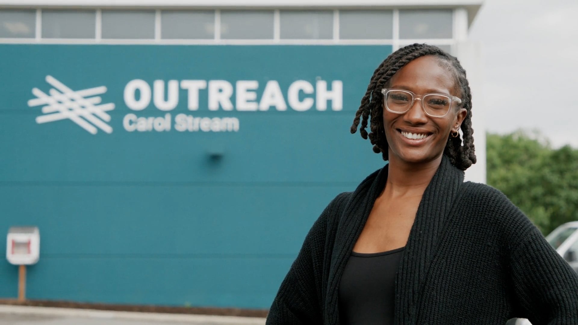 Serena smiling outside the Outreach Carol Stream building