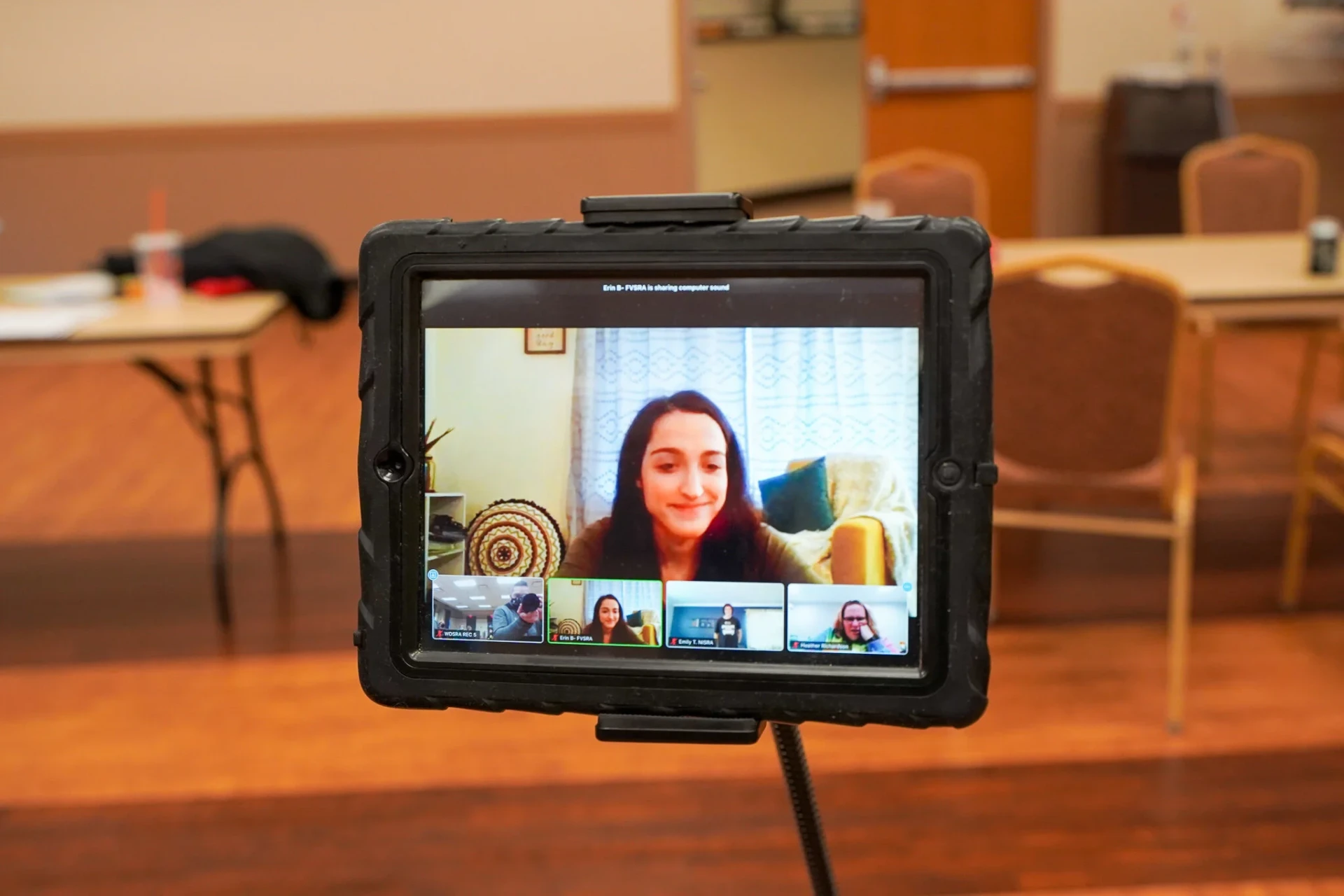 A tablet on a stand showing the virtual dance instructor leading the session