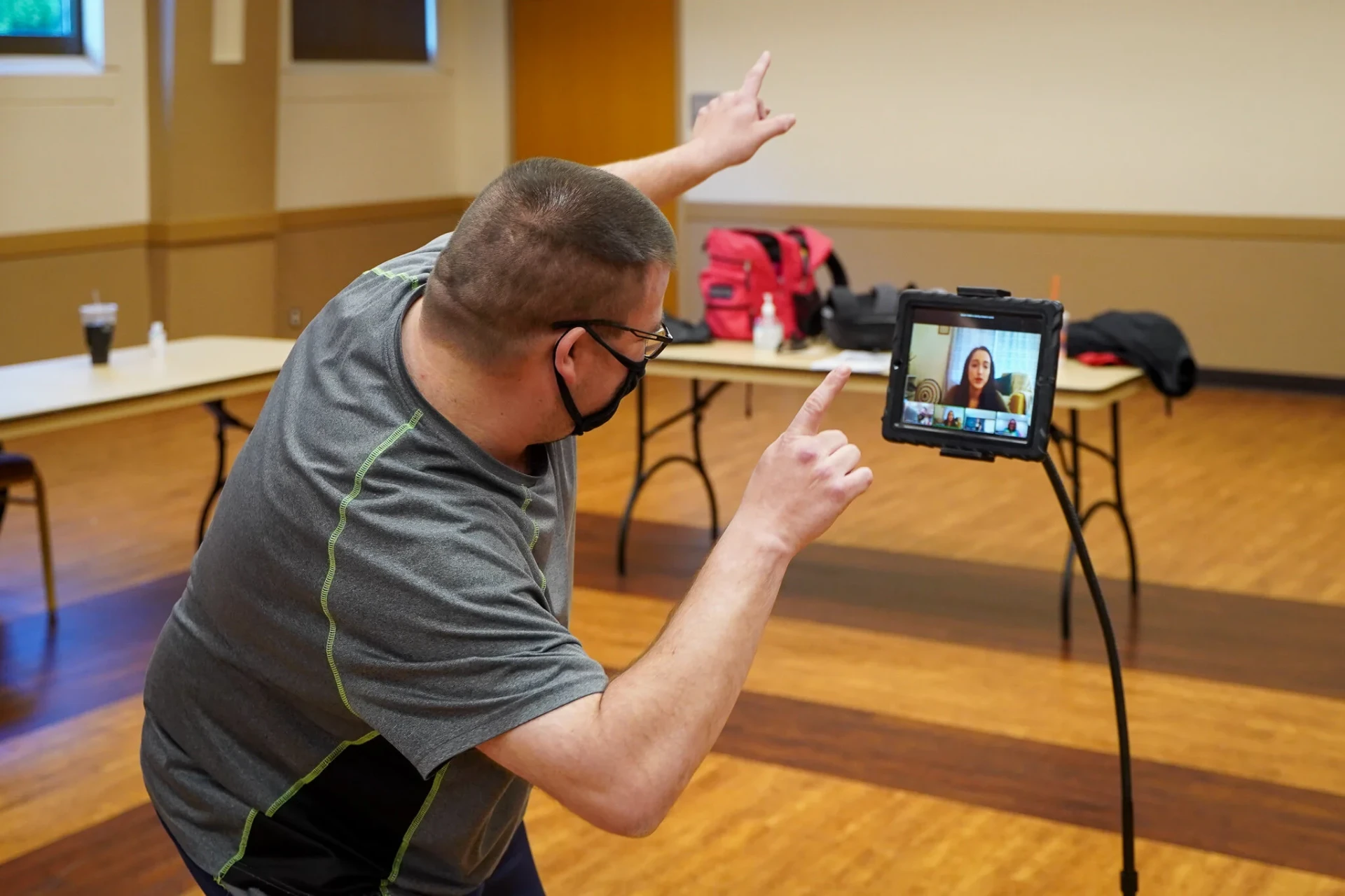 A participant pointing along to the music while facing the tablet screen
